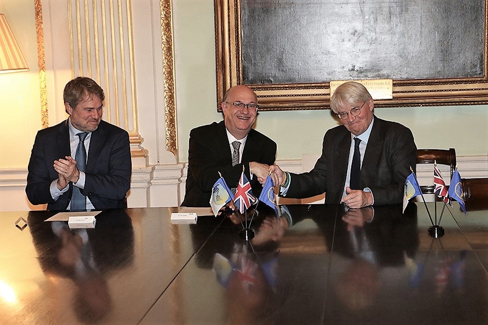 James P. Scriven, Ilan Goldfajn and Andrew Mitchell at the UK Member Country Signing Event