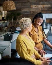 Image of two young women working at a restaurant