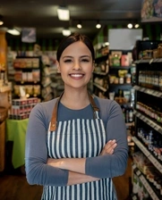 Image of a woman who works at a supermarket smiling