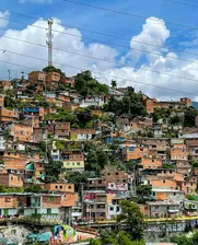 A view of a city with a hill in the background. Daniel Duque on Unsplash. Used under Creative Commons License.
