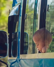 Image of a baby sleeping while traveling in a bus
