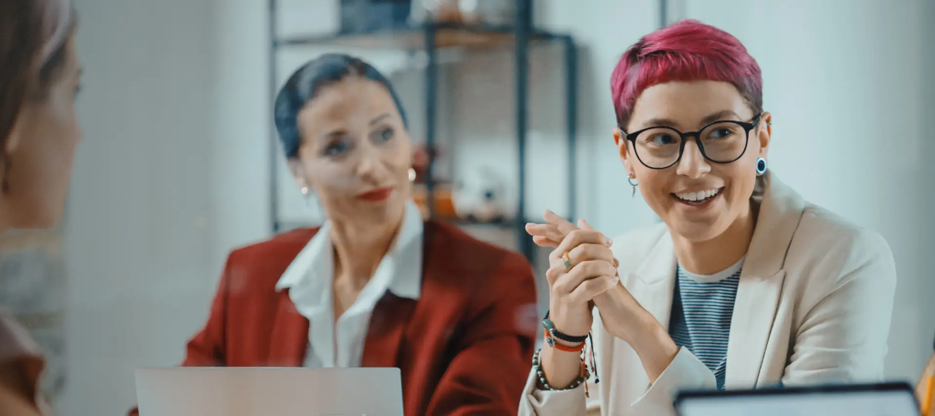 Banner image that portraits a lesbian worker at an office conference room