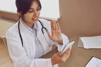 A healthcare professional with a smartphone