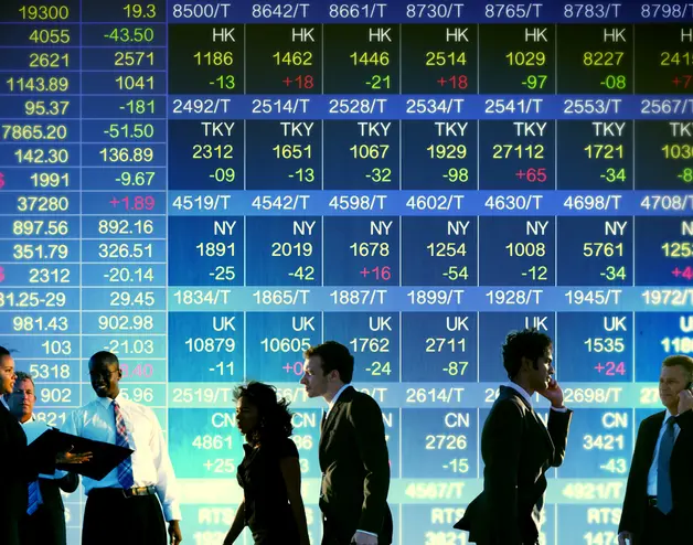 people in front of stock market screen