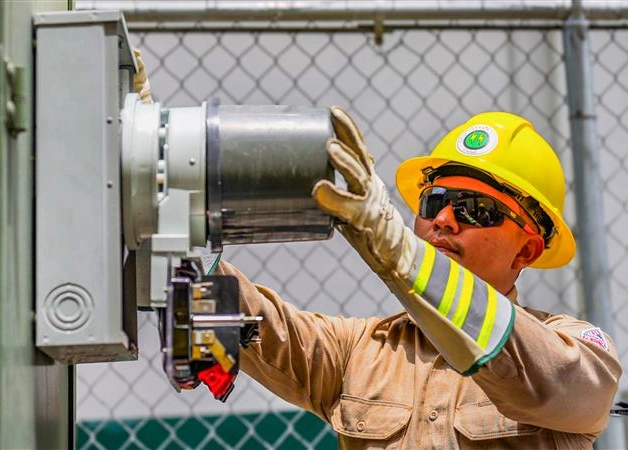 Man working on electric meter