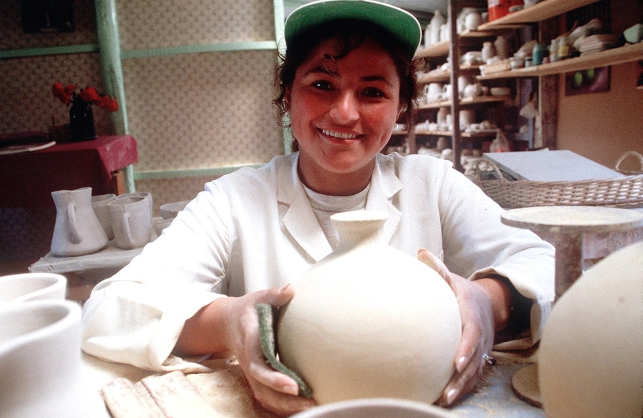 Female microentrepreneur working in ceramic store