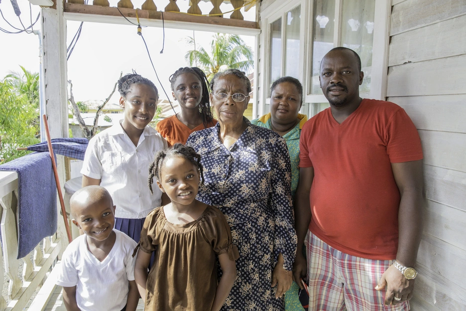 Banner image of a family from Trinidad & Tobago at their house.