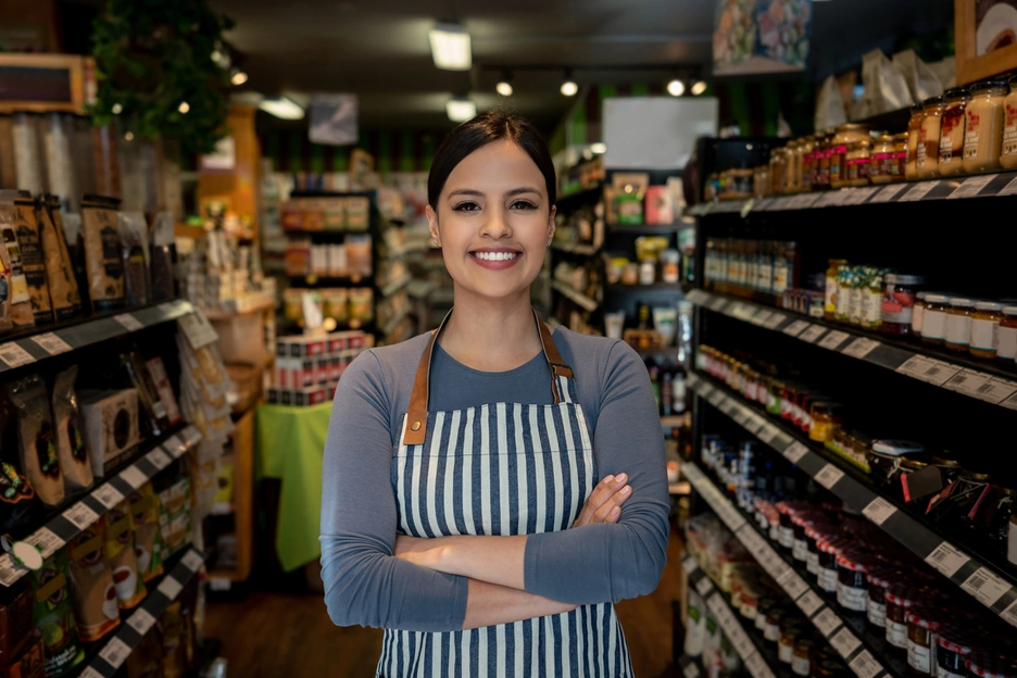 Image of a woman who works at a supermarket smiling