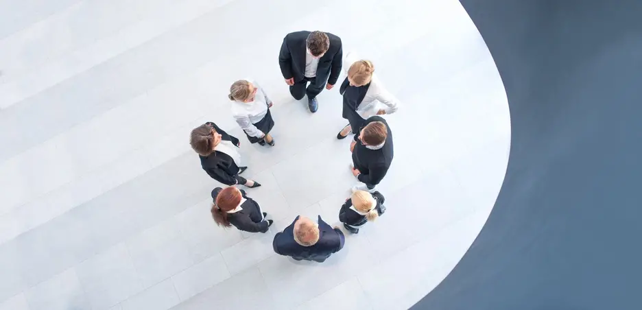 Image showing a group of office workers talking in a circle formation