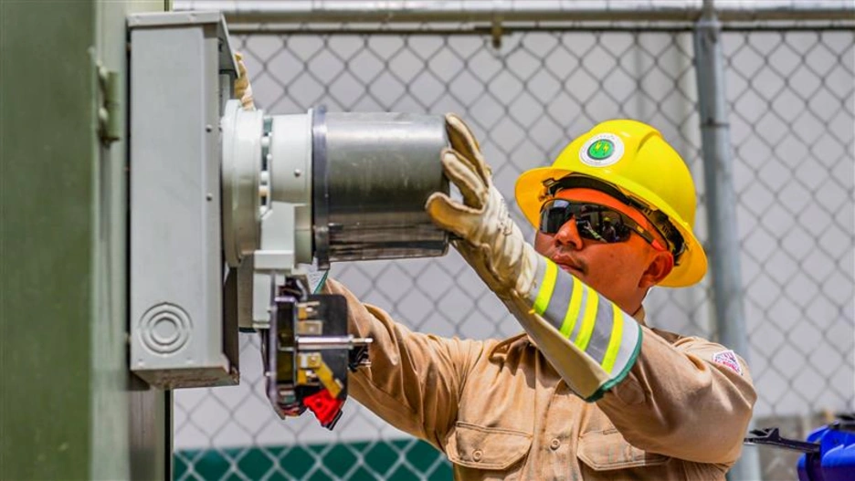 Man working on electric meter
